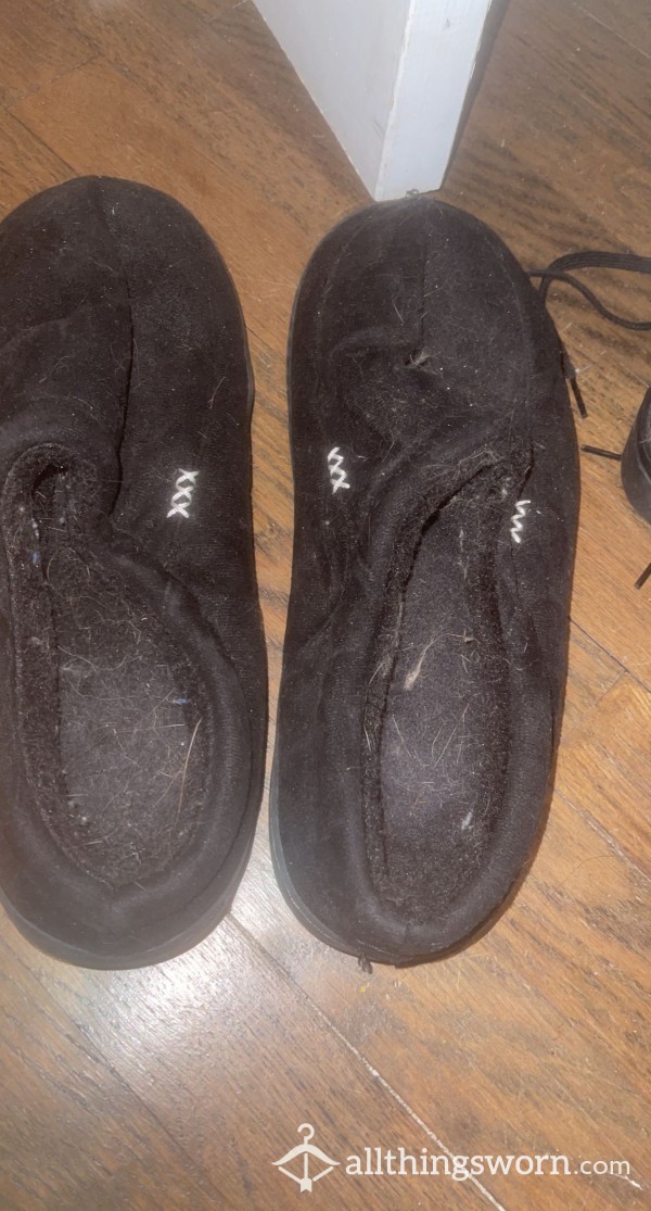 WORN BLACK SLIPPERS